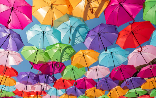 Colorful umbrellas floating in the sky