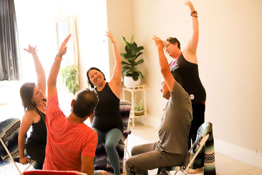 Superfit Hero Body Positive Fitness Trainer Lisa Clements Feeney practicing accessible chair yoga