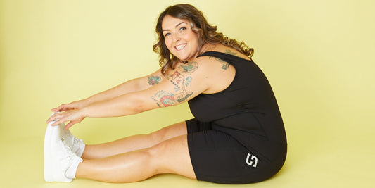 Plus size model wearing Superfit Hero's Pocket Short Bodysuit, winner of the 2023 Women's Health Fitness Awards.