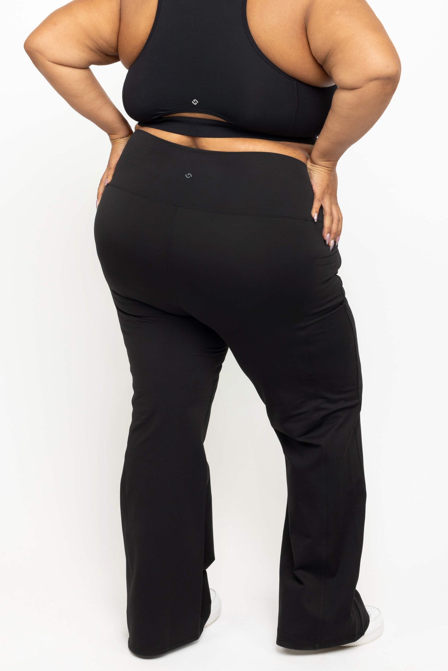 Back view of Superfit Hero black plus size flare leggings with pockets size 3X