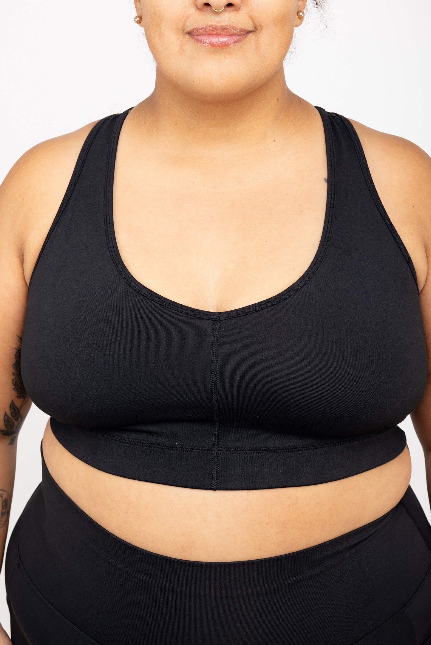 Close-up of model wearing Superfit Hero SuperHold™ V-neck Sports Bra, color Black, Size 2X