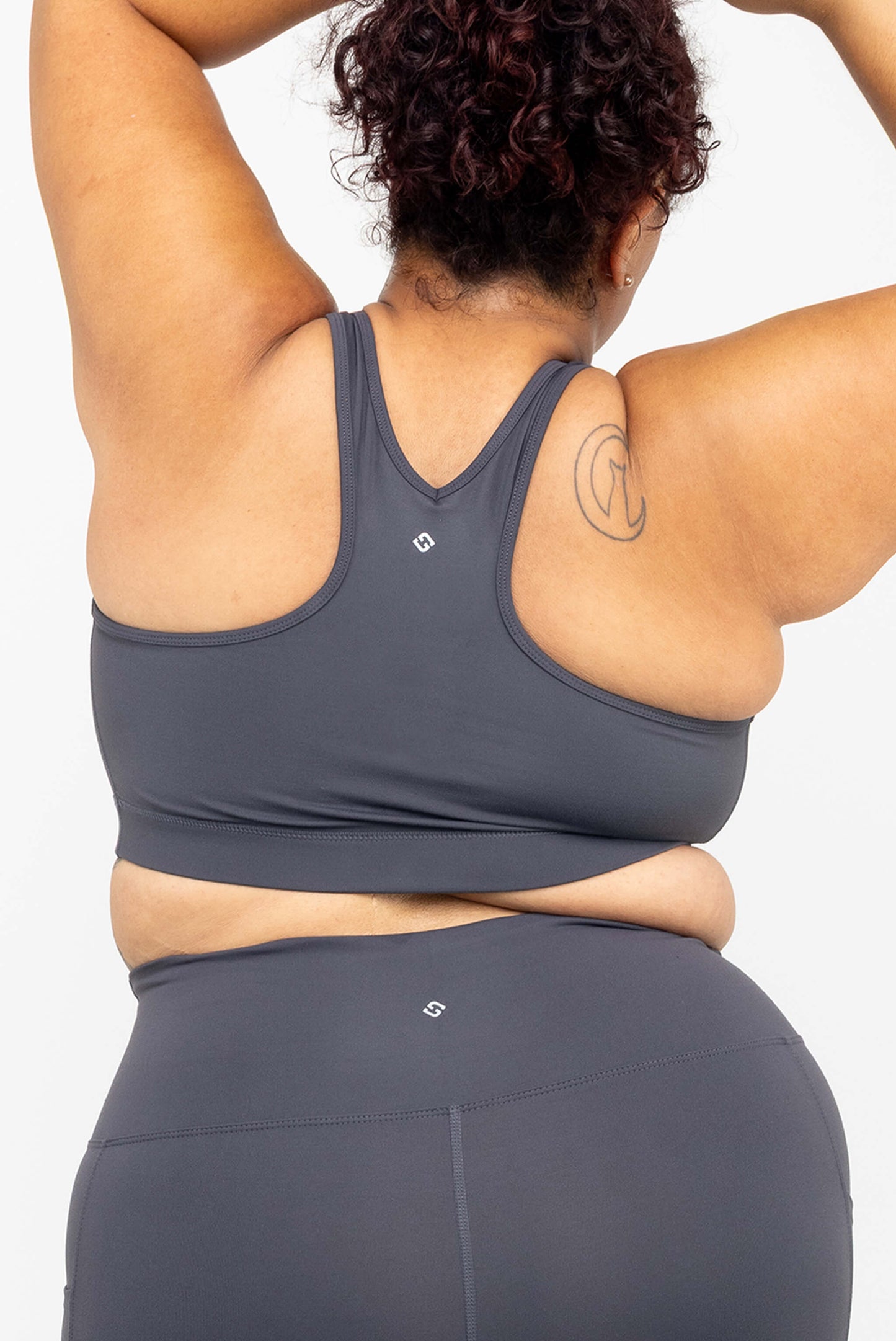 Back view of model with her arms up, wearing Superfit Hero SuperHold™ V-neck Sports Bra in color Carbon, size 2X