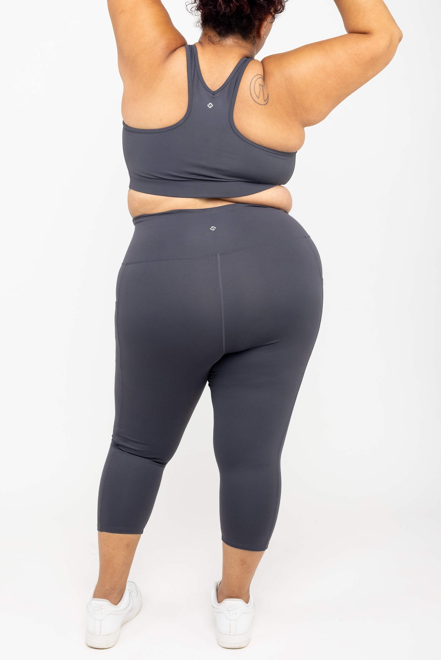 Back view of model wearing Superfit Hero SuperHold™ Pocket Capris, color Carbon, size 2X