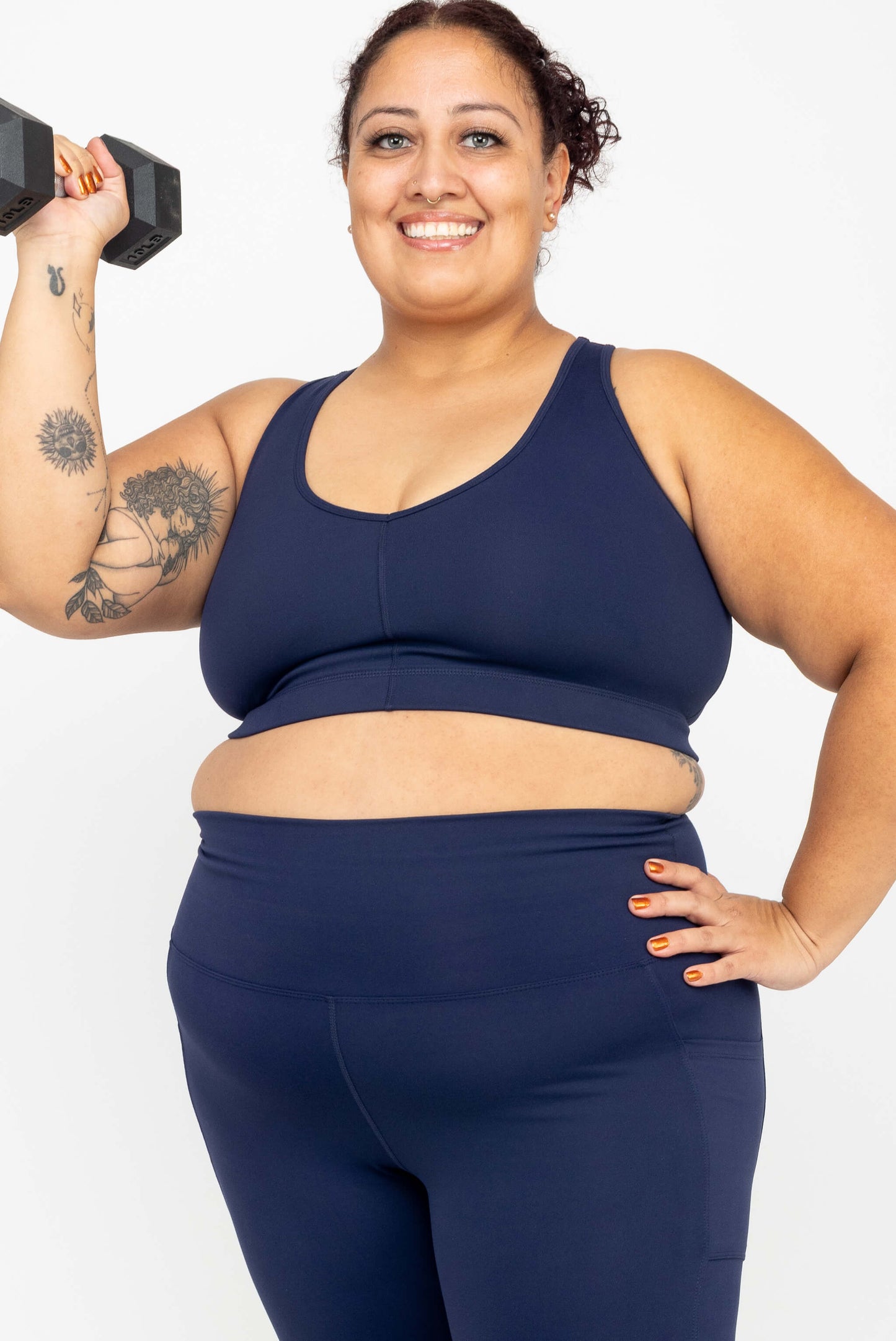 Model holding dumbbell wearing Superfit Hero SuperHold™ V-neck Sports Bra, color Navy, size 2X