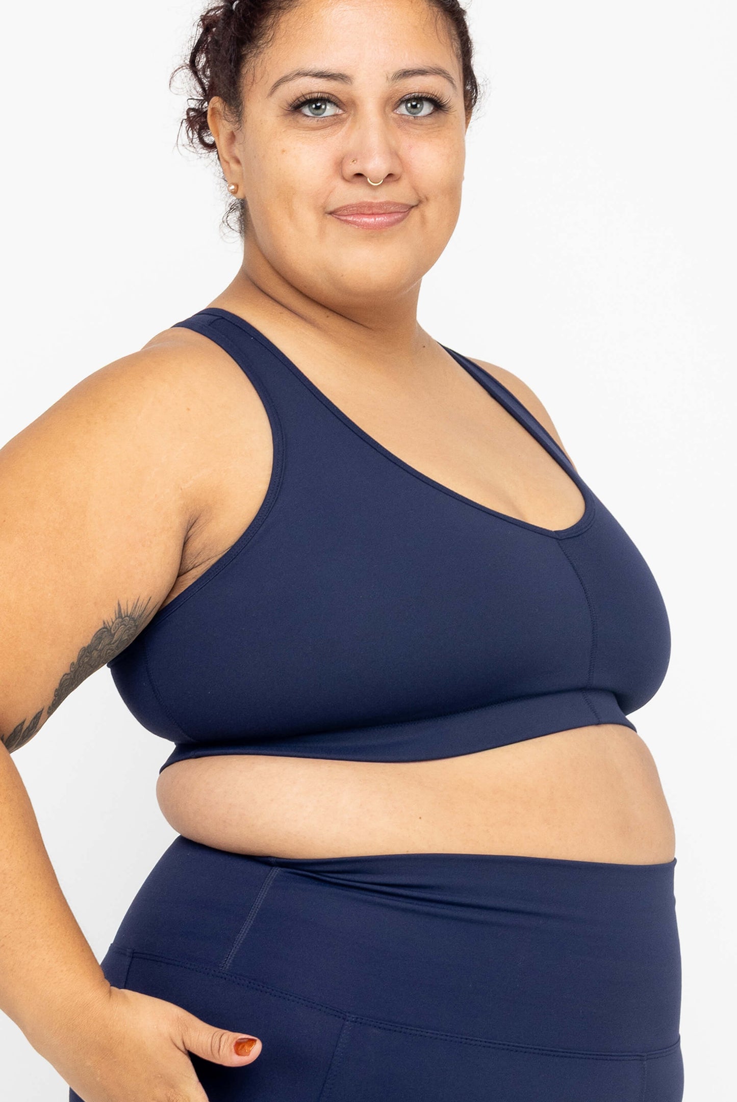 Profile view of model wearing Superfit Hero SuperHold™ V-neck Sports Bra, color Navy, size 2X