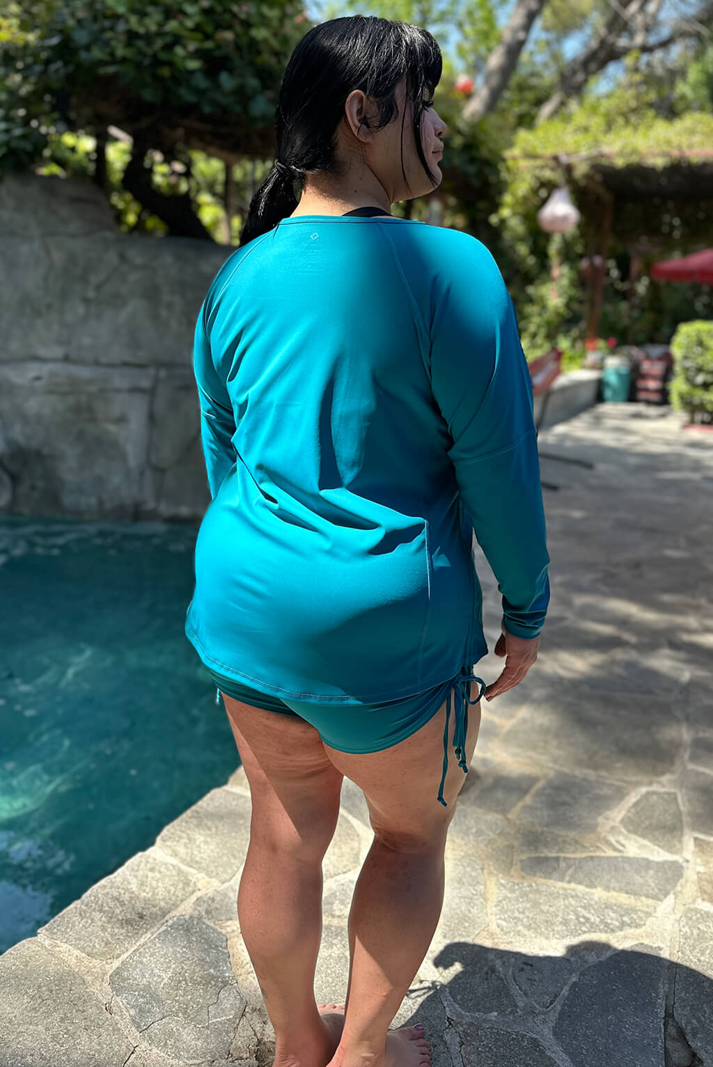 Back view of plus size swim rash guard in teal color