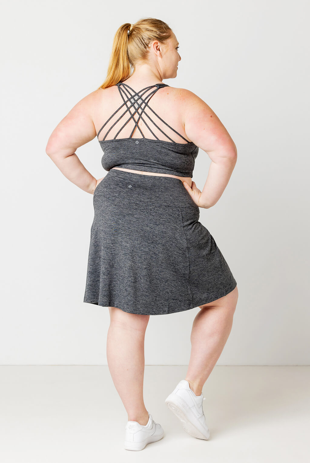 Back view of plus size model wearing Superfit Hero SuperSoft Skort