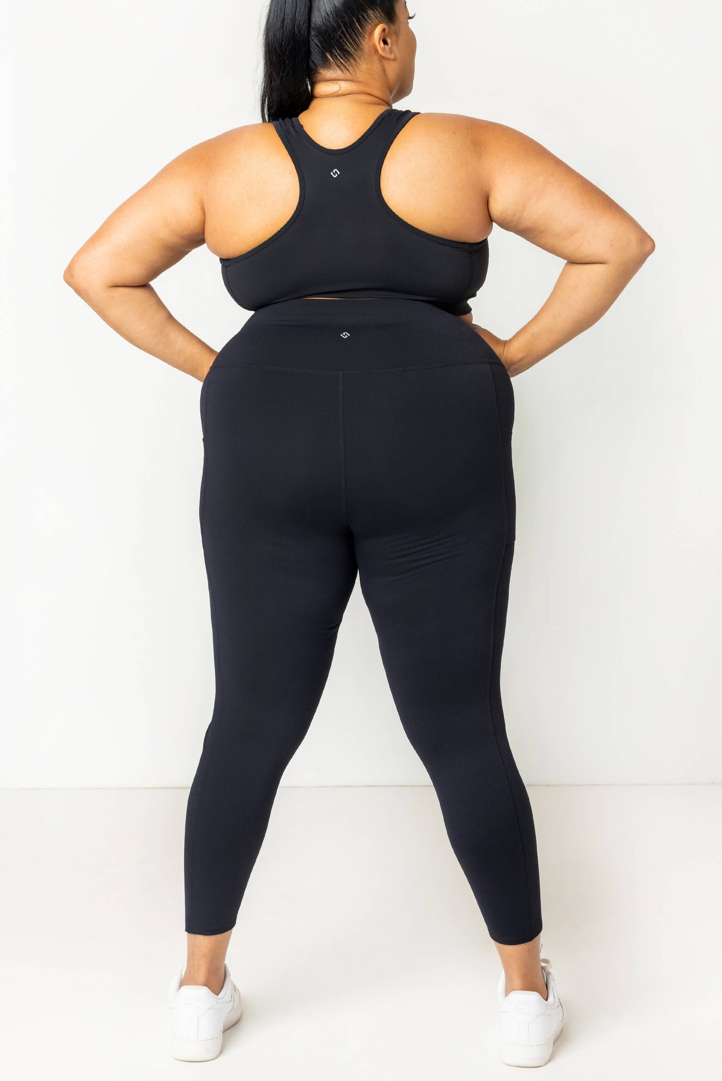 Back view of Plus size model wearing SuperHold 7/8 pocket leggings in size 2X