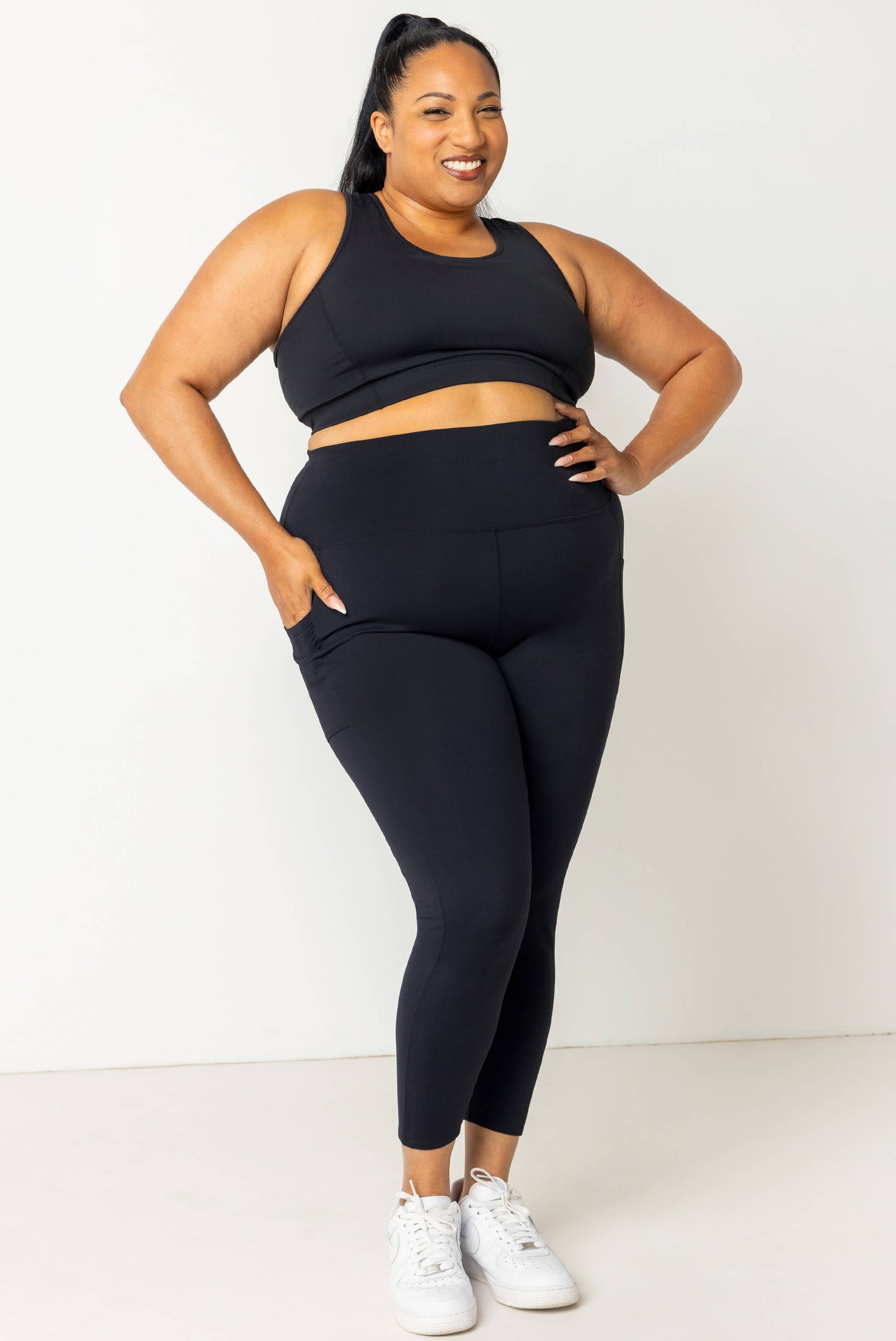 Plus size model wearing SuperHold 7/8 pocket leggings in size 2X