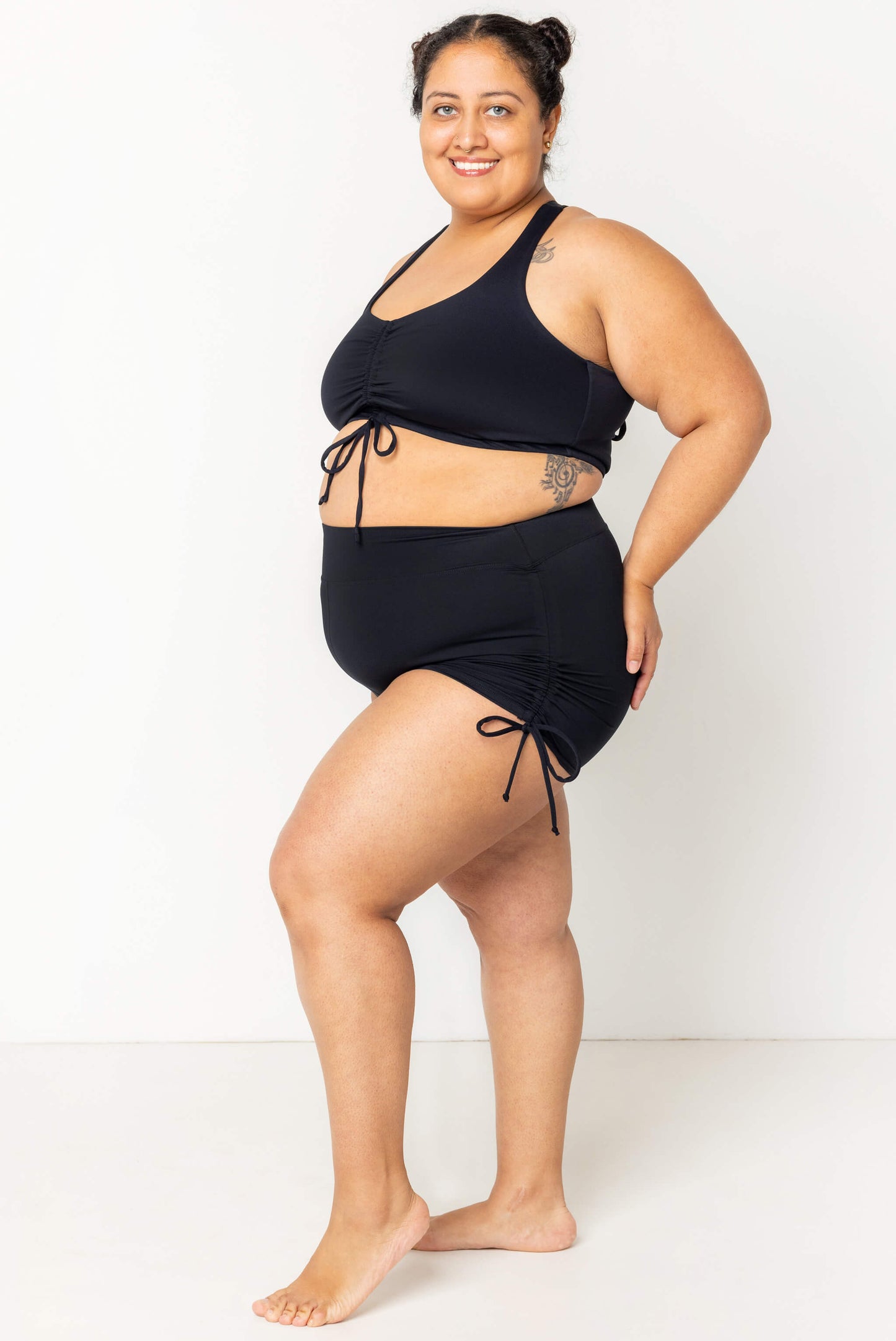 Plus size model wearing swim booty shorts and matching cinched bikini top