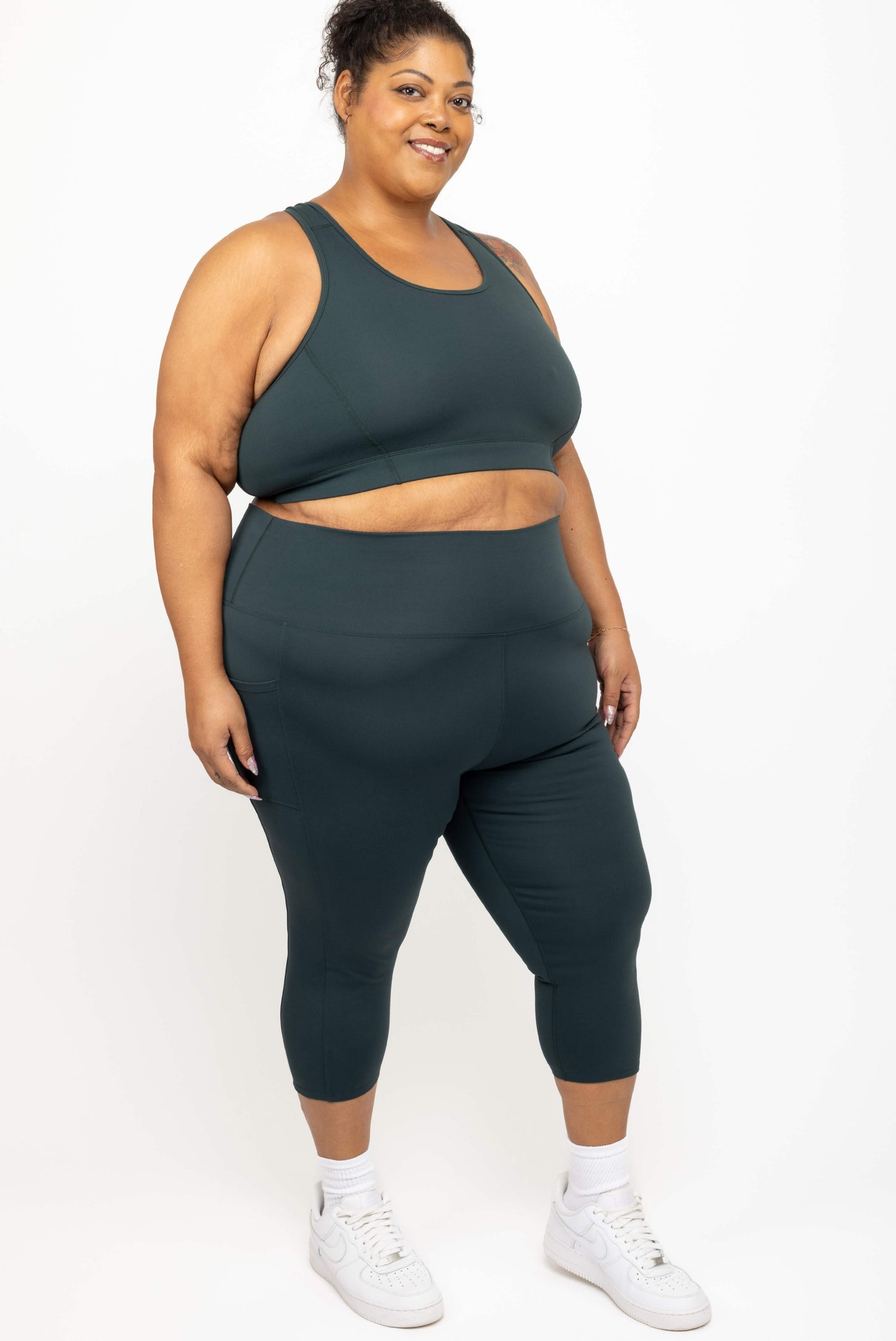 Model wearing Superfit Hero plus size compression capris size 3X color evergreen