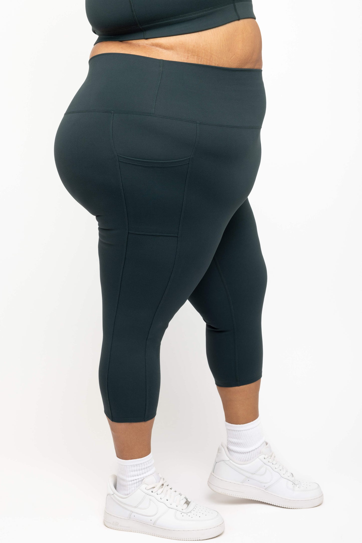 Profile view of Superfit Hero plus size compression capris size 3X color evergreen