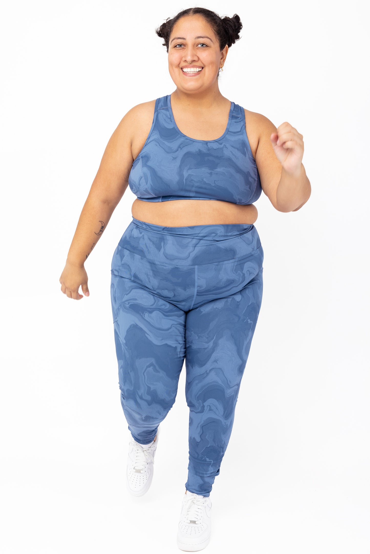 plus size model running in SuperHold pocket leggings size 2x blue print