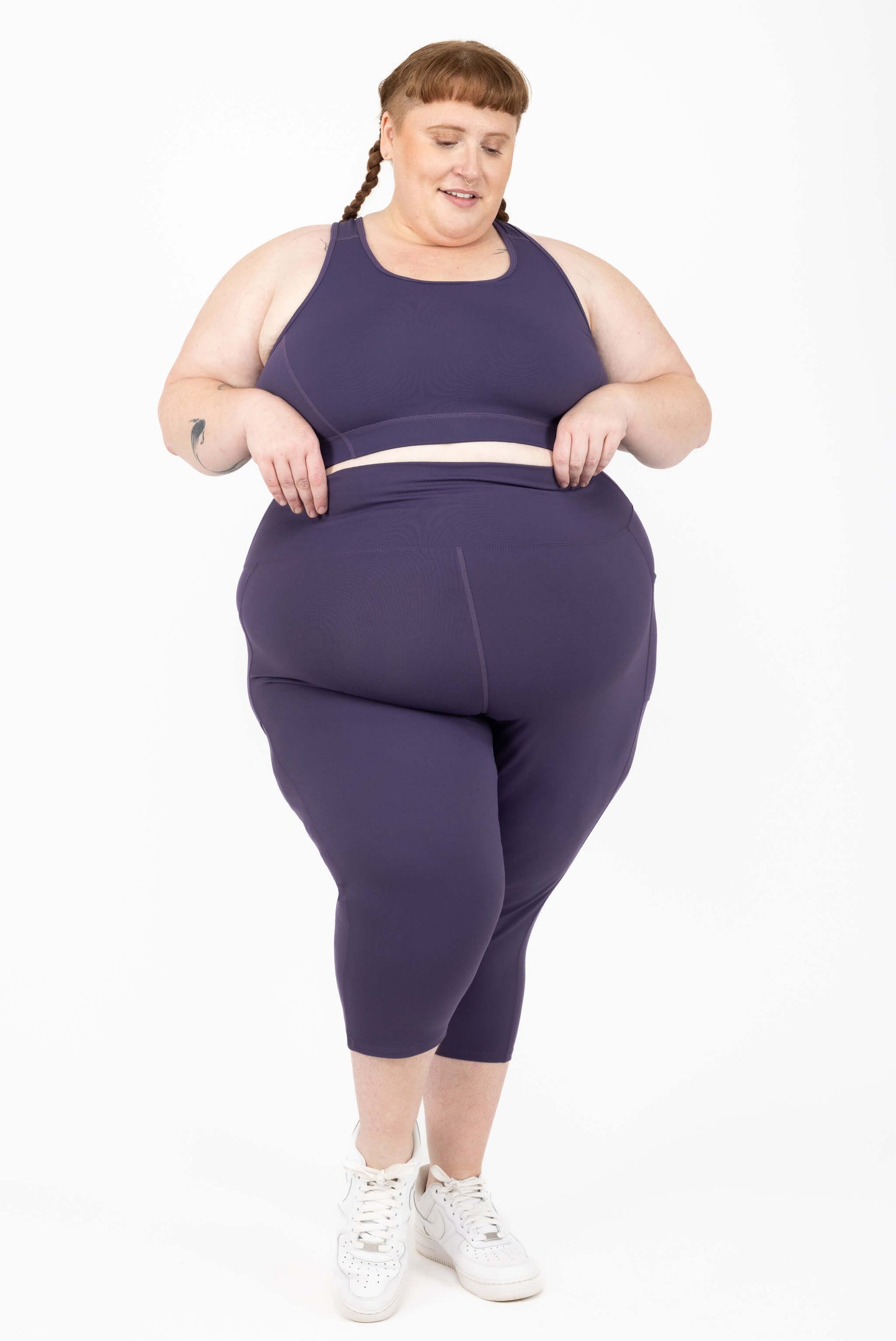 Size 5x model in plus size compression capris with pockets - deep purple