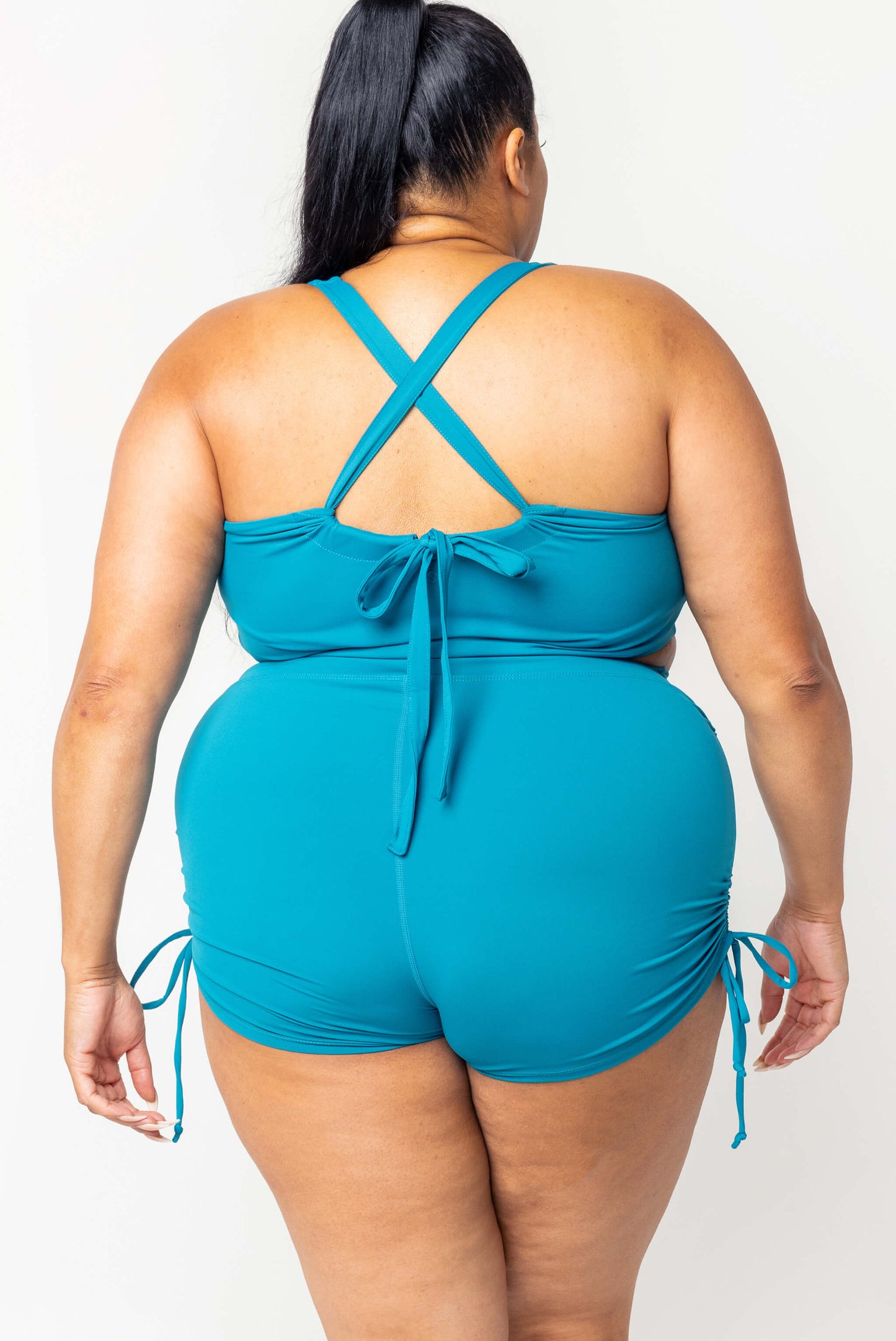 Back view of plus size swim booty shorts in teal