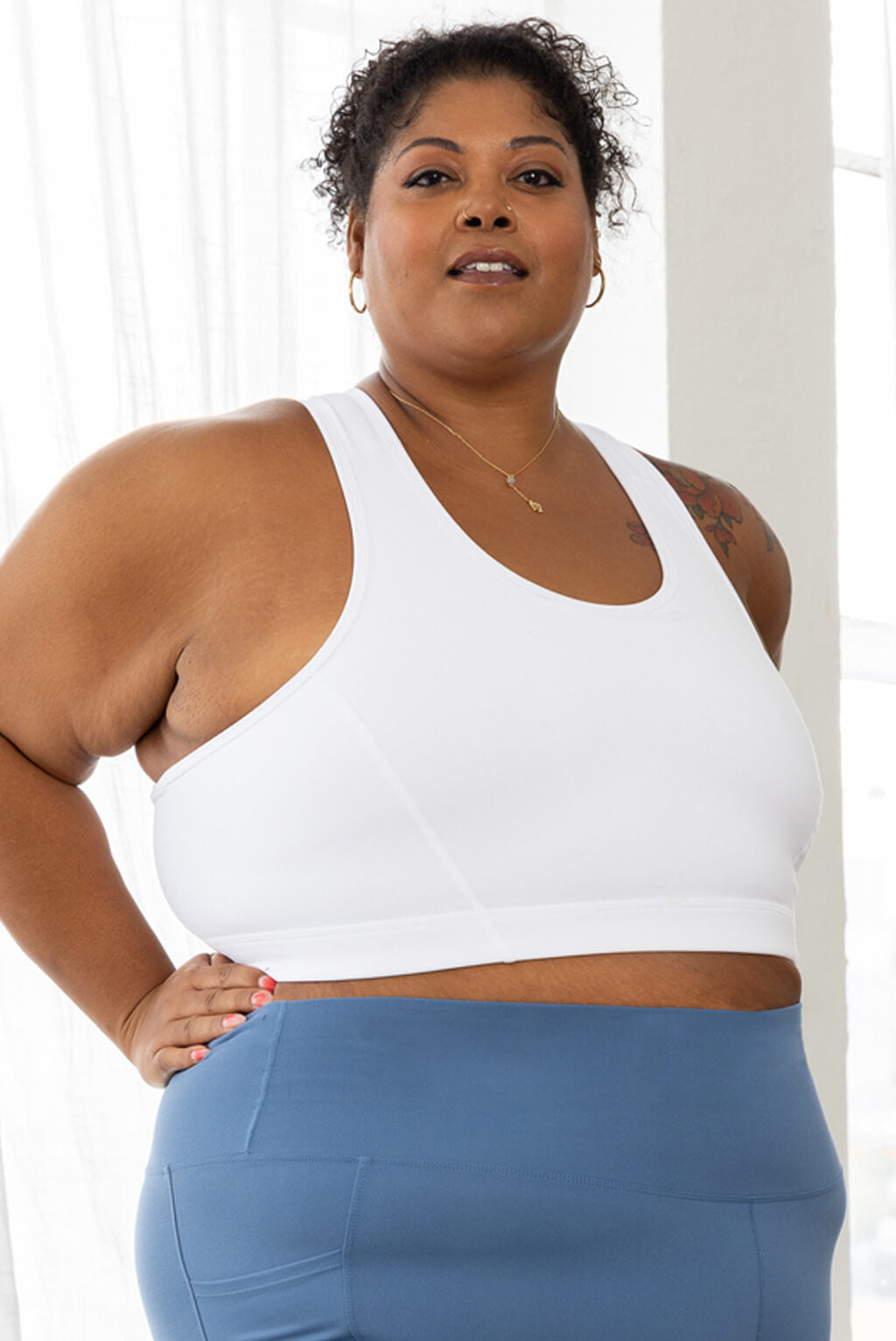 plus size model wearing white racerback bra in size 3X