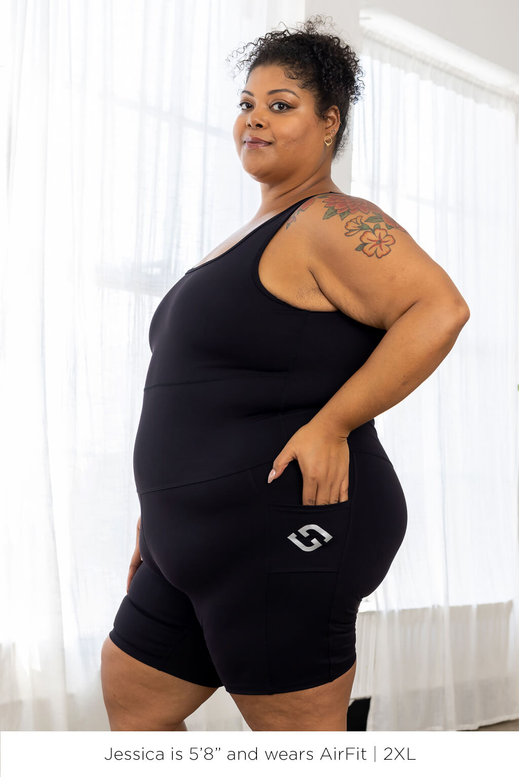 Plus size women wearing Bodysuit Black in size 2XL.