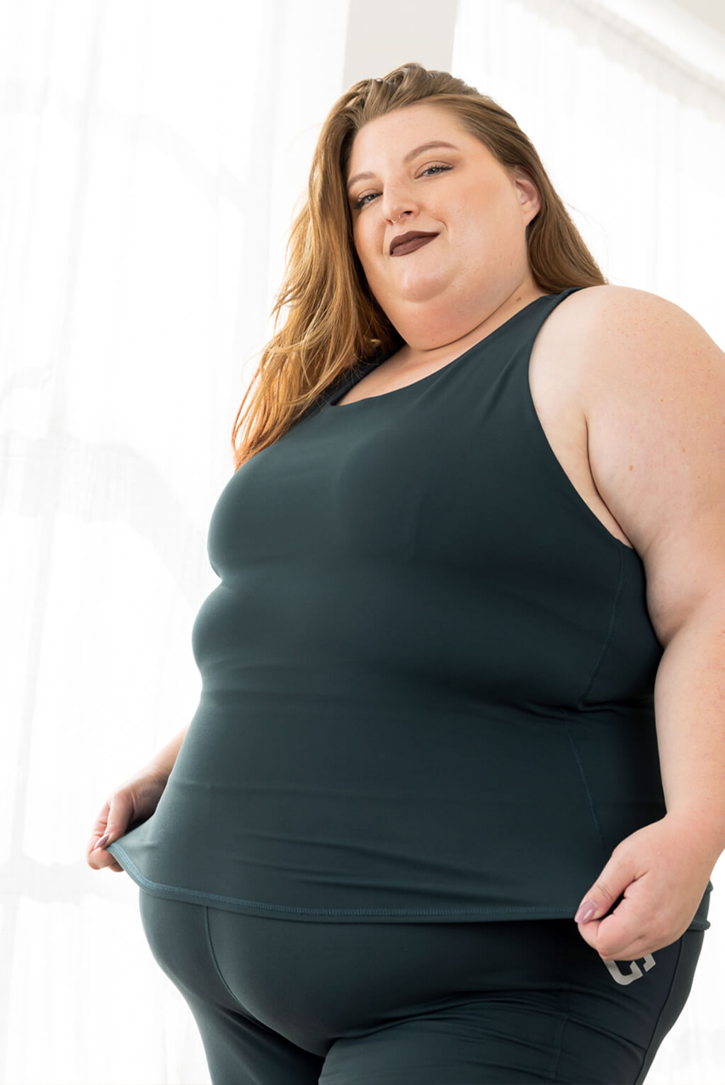 Woman wearing Shelf Bra Tank Top in Evergreen by Superfit Hero.