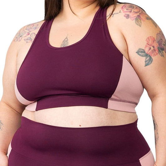 A plus size woman wearing a sports bra by Superfit Hero.