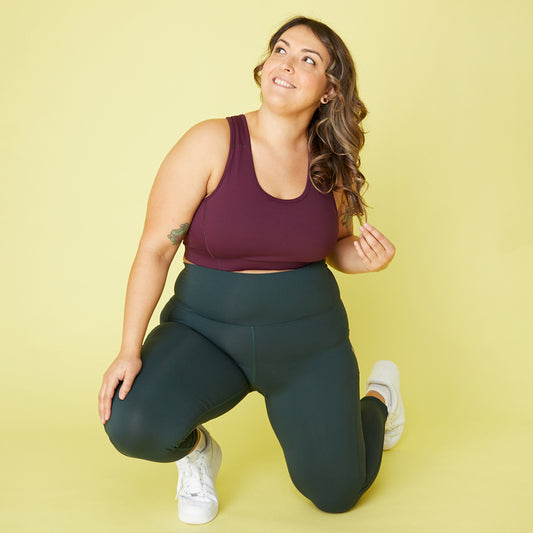Plus size woman wearing Superfit Hero's set in colors Burgundy and Evergreen.