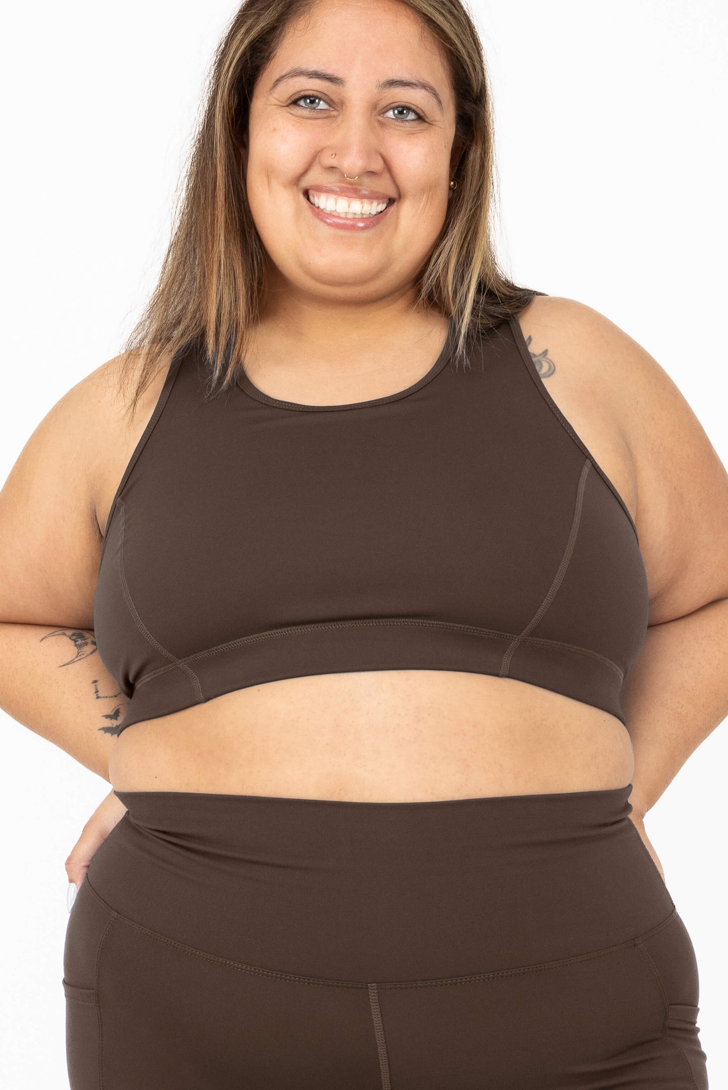 A smiling woman wearing SuperHold Racerback Sports Bra in Chocolate Brown, Size 2X