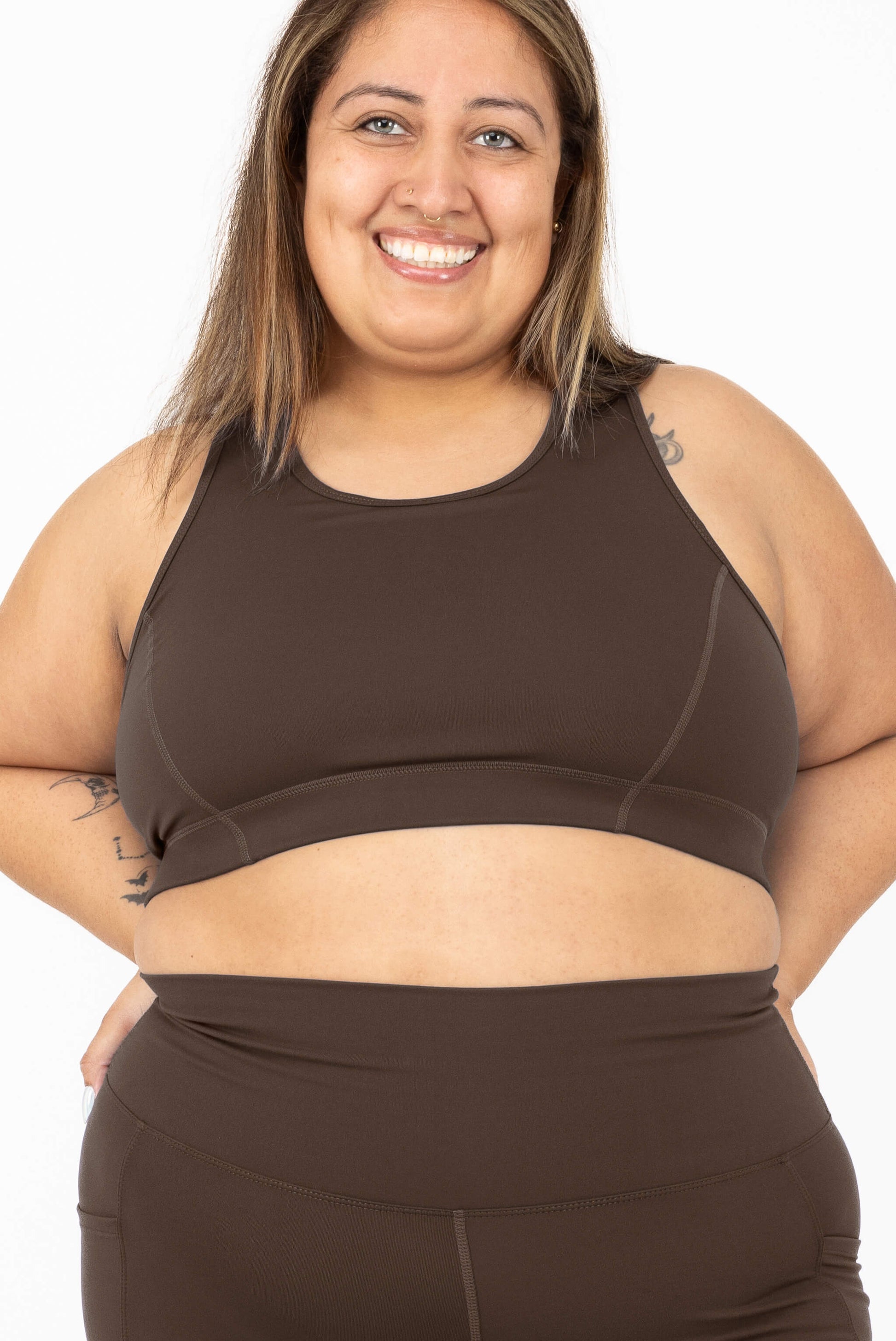 A smiling woman wearing SuperHold Racerback Sports Bra in Chocolate Brown, Size 2X