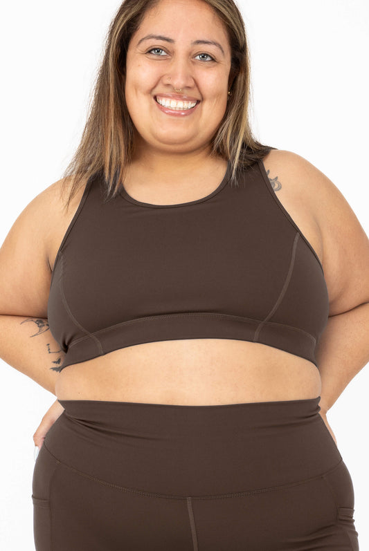 A smiling woman wearing SuperHold Racerback Sports Bra in Chocolate Brown, Size 2X