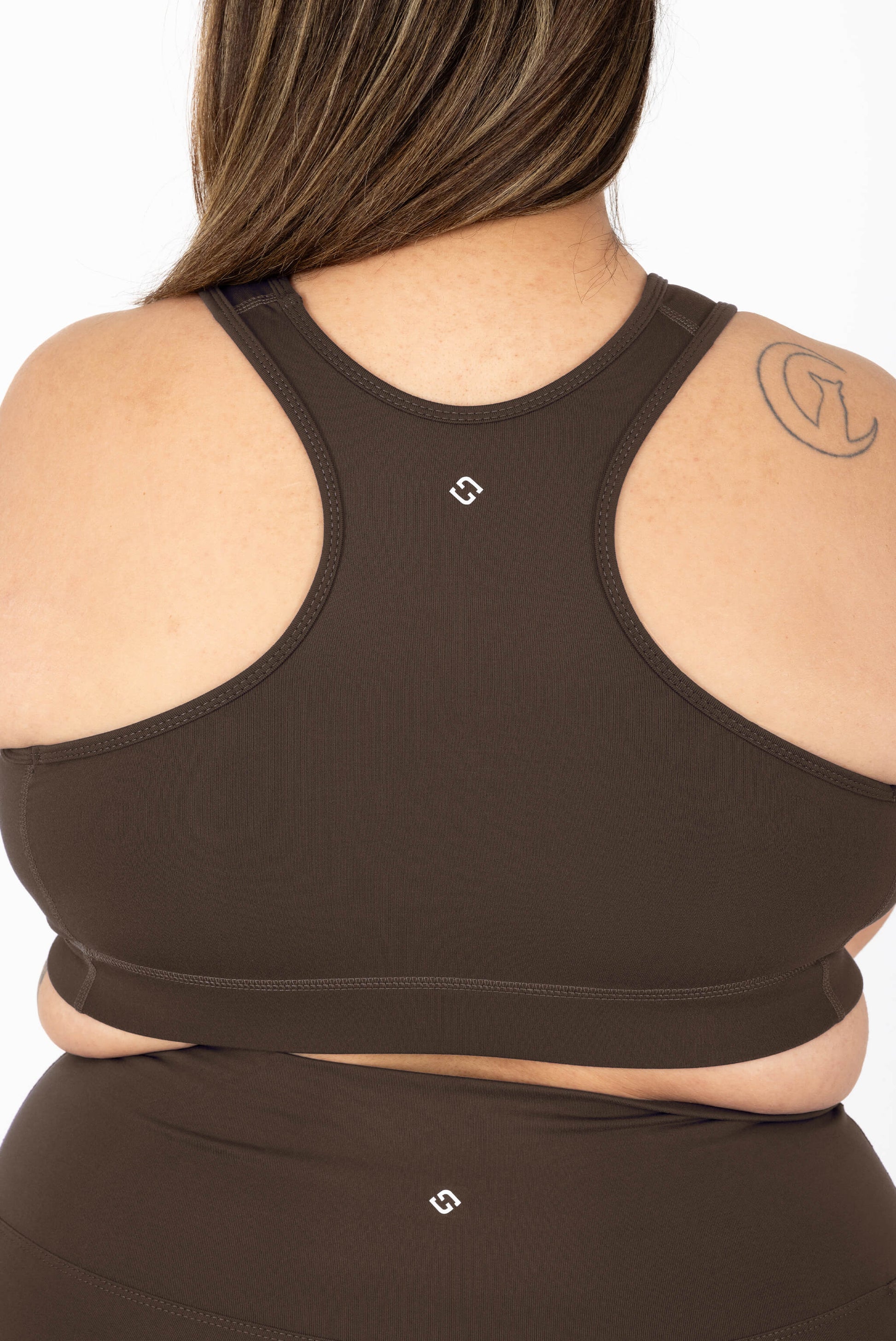 Rear view of a woman wearing SuperHold Racerback Sports Bra in Chocolate Brown and matching bottoms.