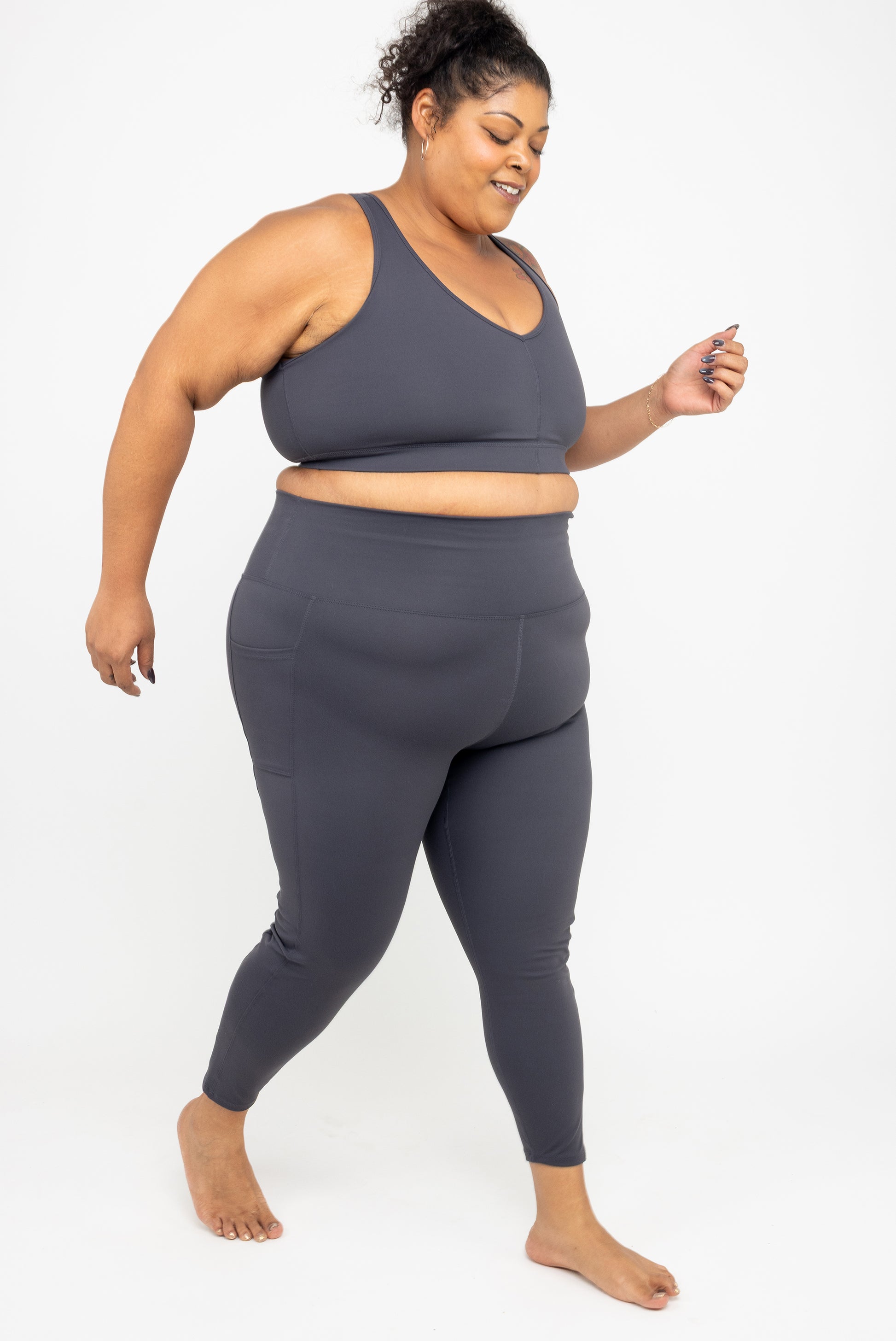 Model running in Superfit Hero SuperHold™ 7/8 leggings in color Carbon, size 3X