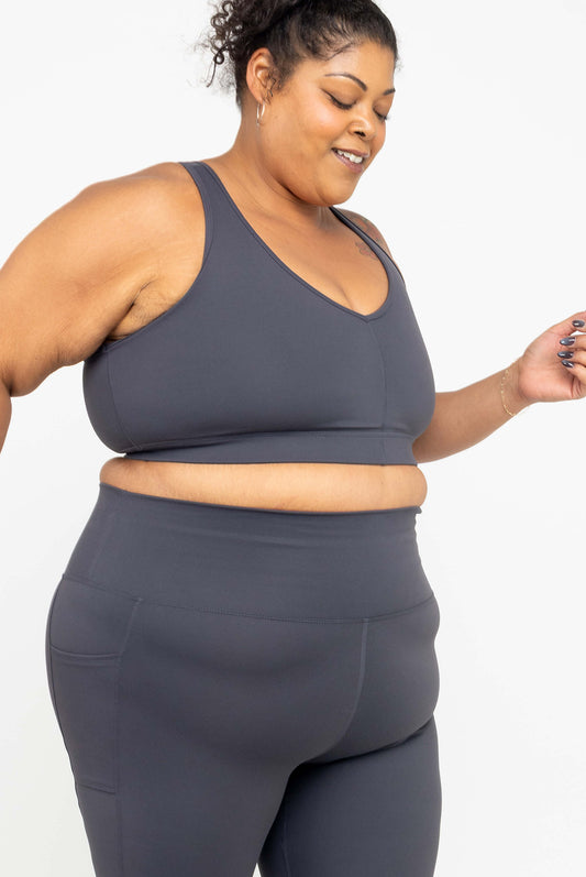 Model wearing Superfit Hero SuperHold™ V-neck Sports Bra in color Carbon, size 3X