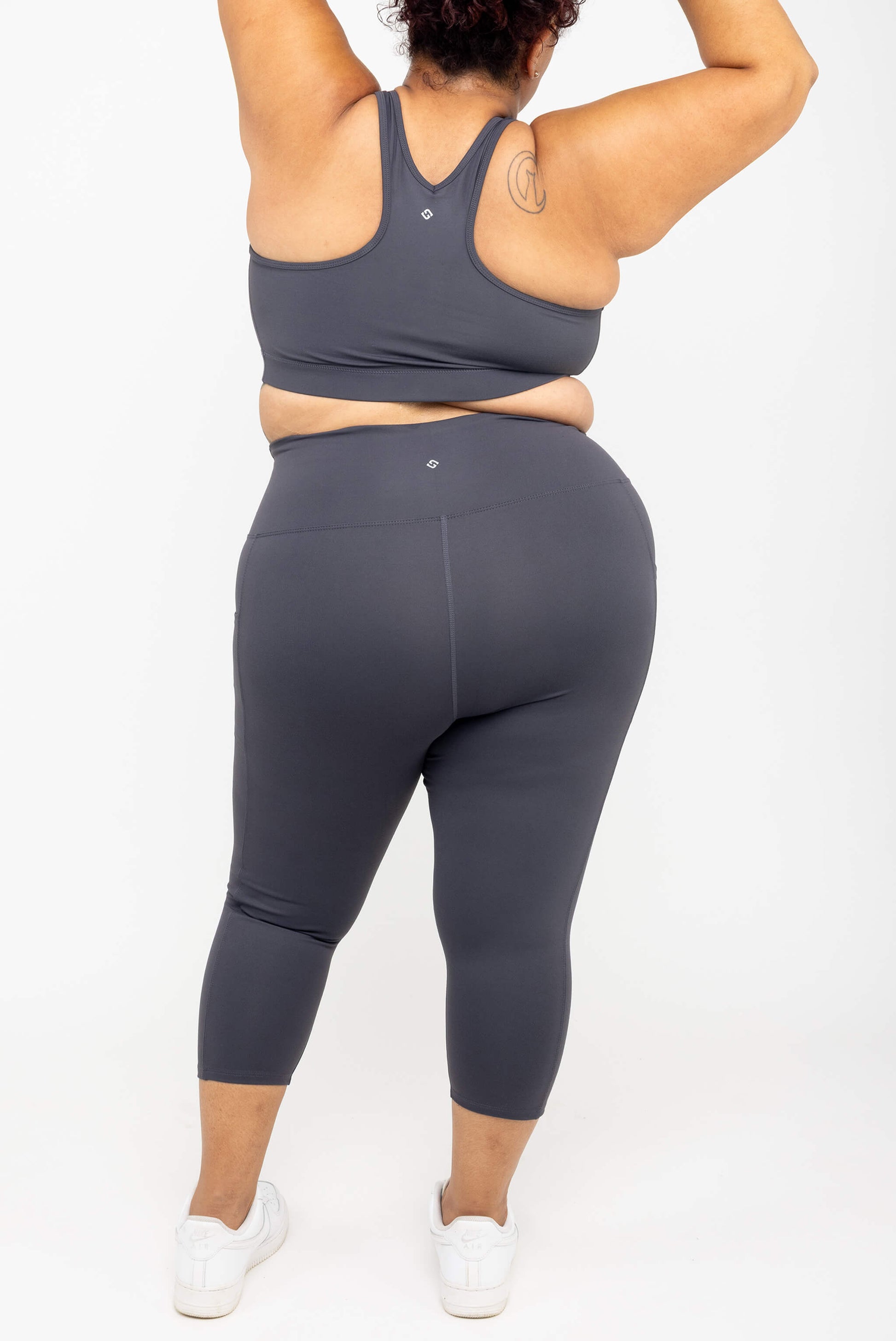 Back view of model wearing Superfit Hero SuperHold™ Pocket Capris, color Carbon, size 2X