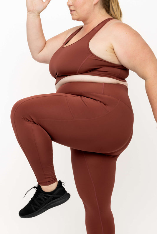 Crop view of model in running pose wearing Cinnamon SuperCool leggings