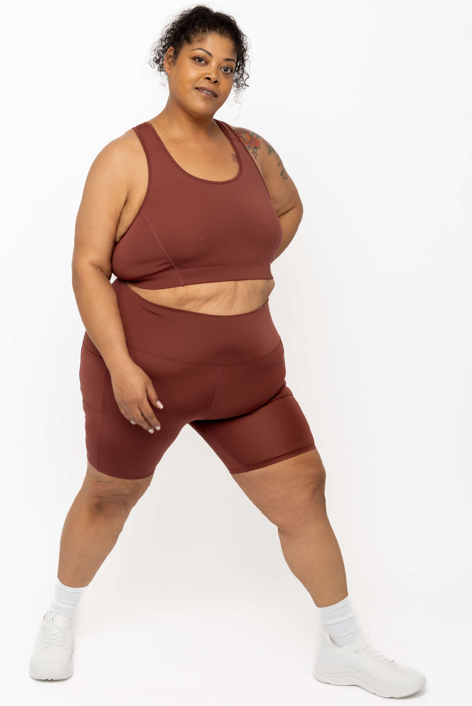 Full body view of model wearing matching set of Cinnamon SuperCool shorts and bra 