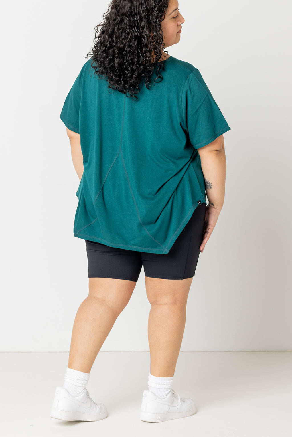 Back view full body of plus size flow tee in forest green size 3X