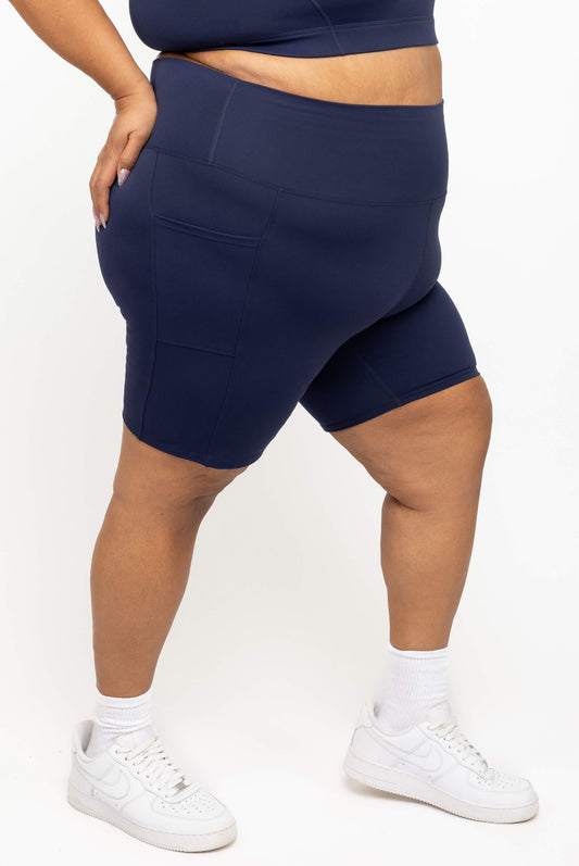 Profile view of Superfit Hero plus size compression biker shorts in navy size 3X