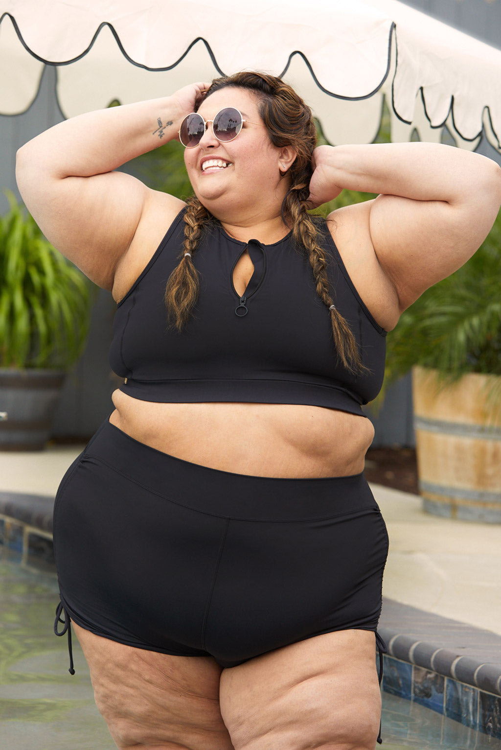 Plus size model wearing size 4X Swim booty shorts with ties at the sides