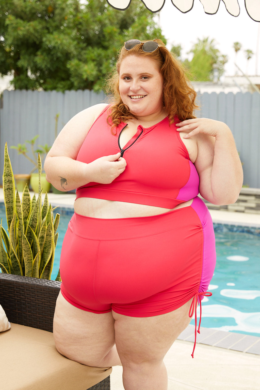 Plus size model wearing size 5X colorblock swim booty shorts with ties on the side.