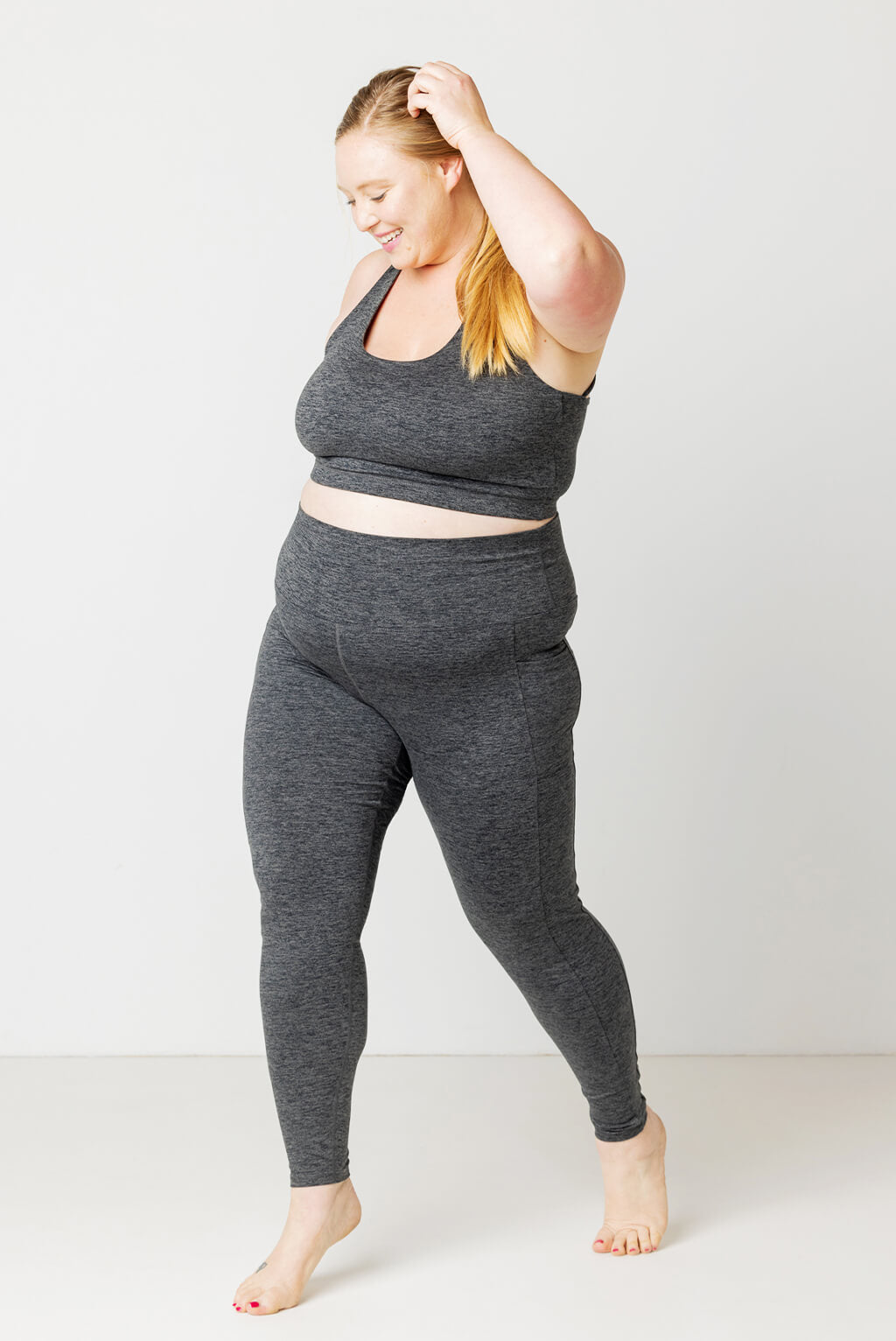 2X model posing in Superfit Hero plus size SuperSoft leggings with pockets