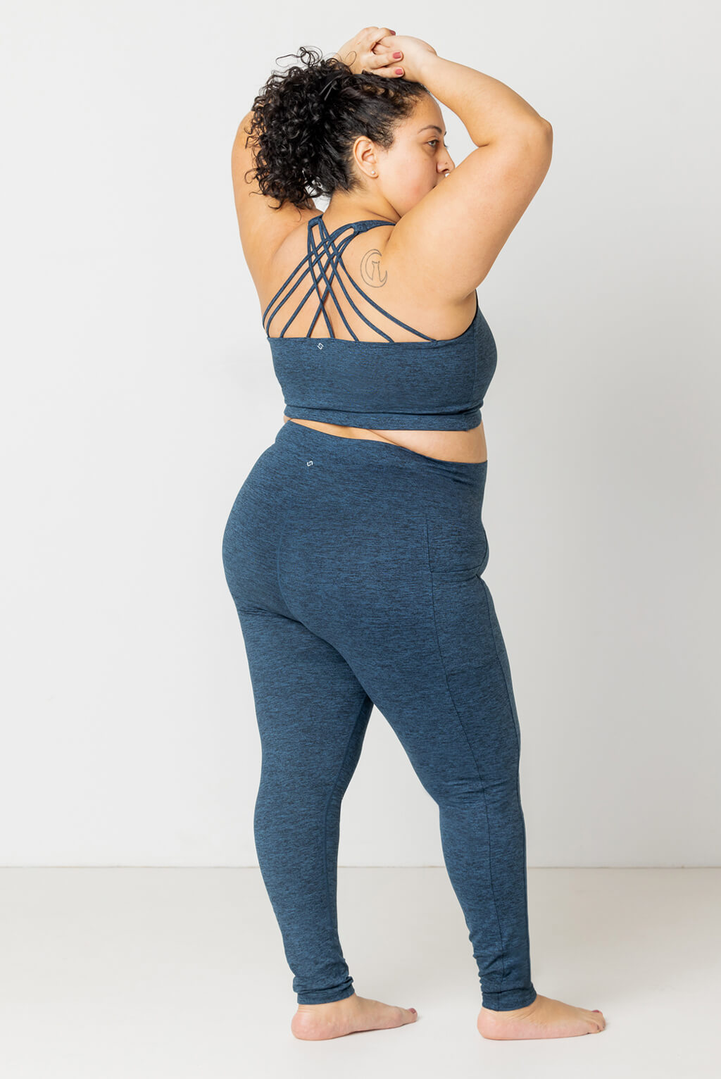 Back view of plus size model wearing Superfit Hero SuperSoft Leggings in Heather Navy