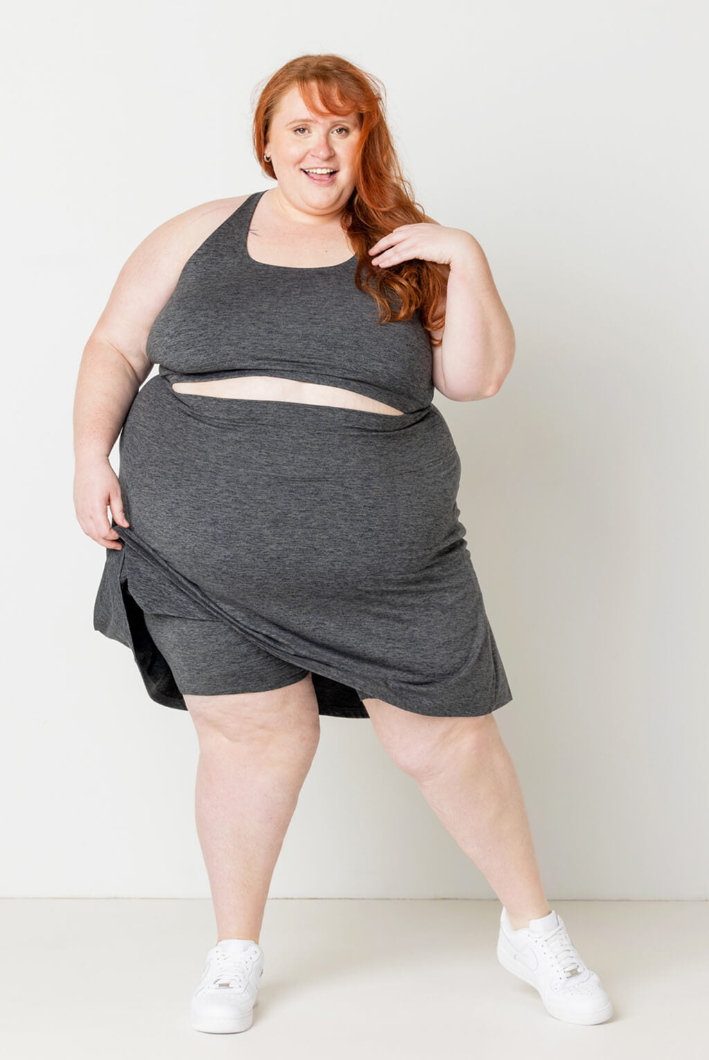 Plus size model shows off shorts under SuperSoft Skort in Heather gray