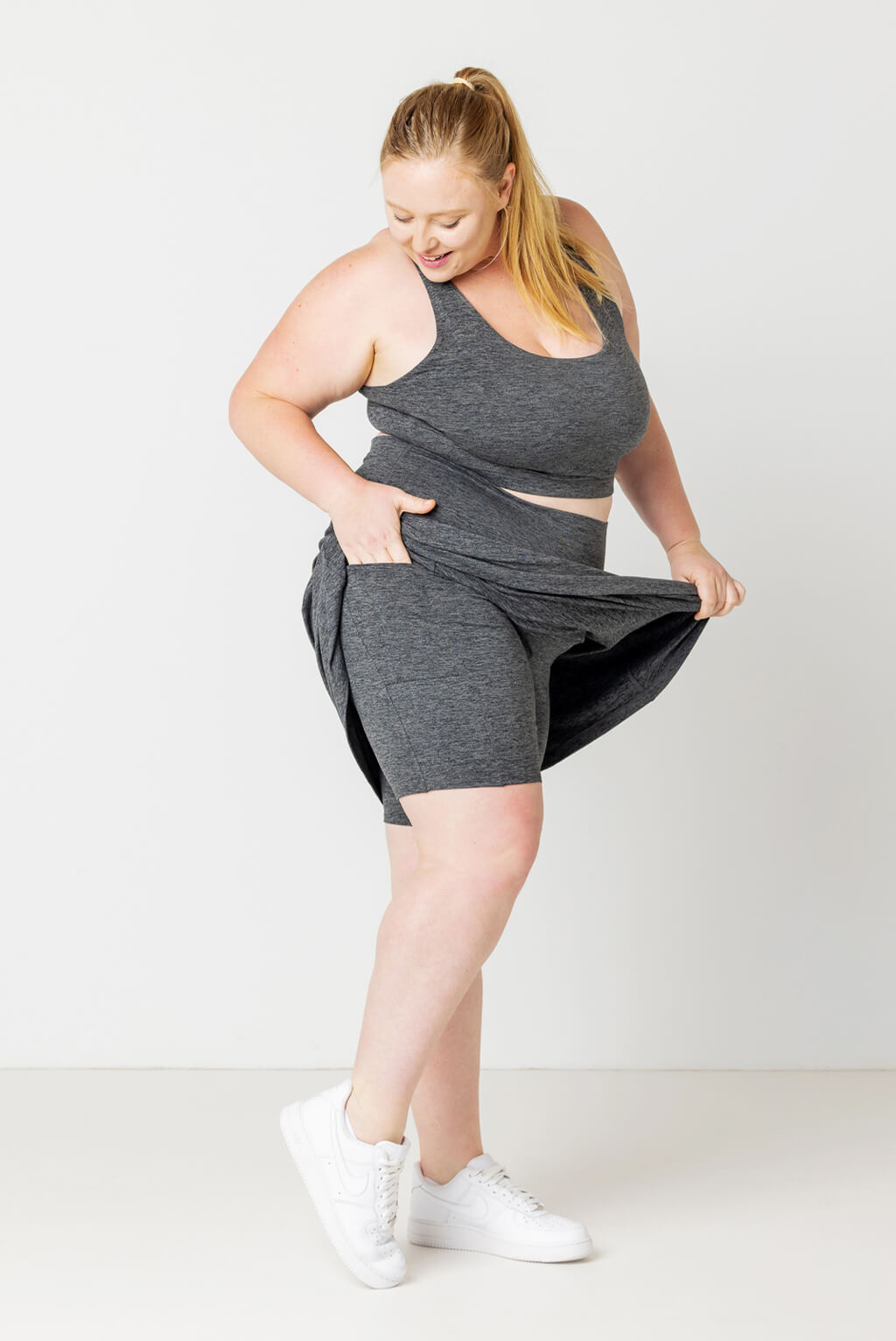 Full profile view of size 2X model showing off shorts with pockets under SuperSoft plus size Skort