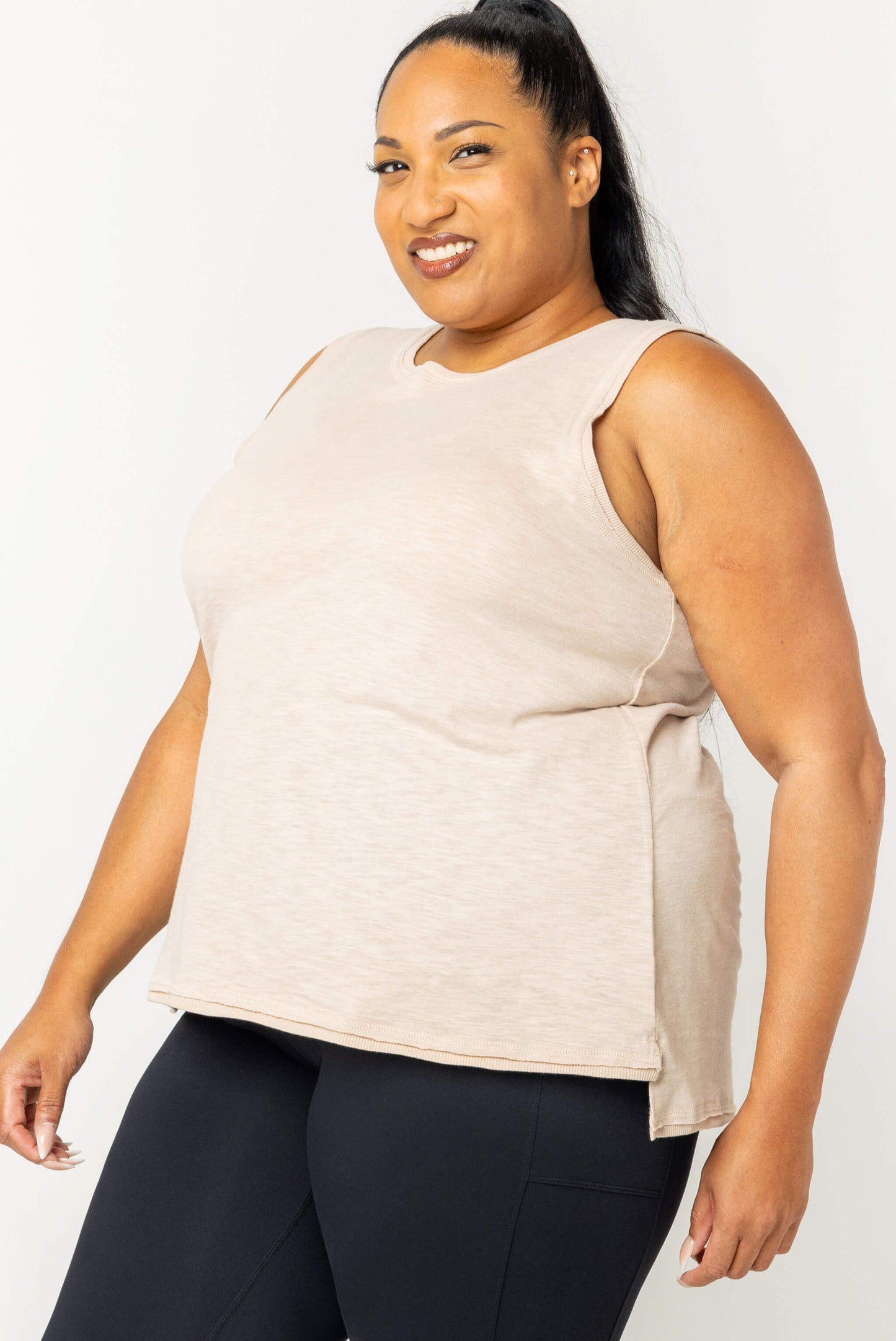 Plus size model wearing textured muscle tank in size 2X