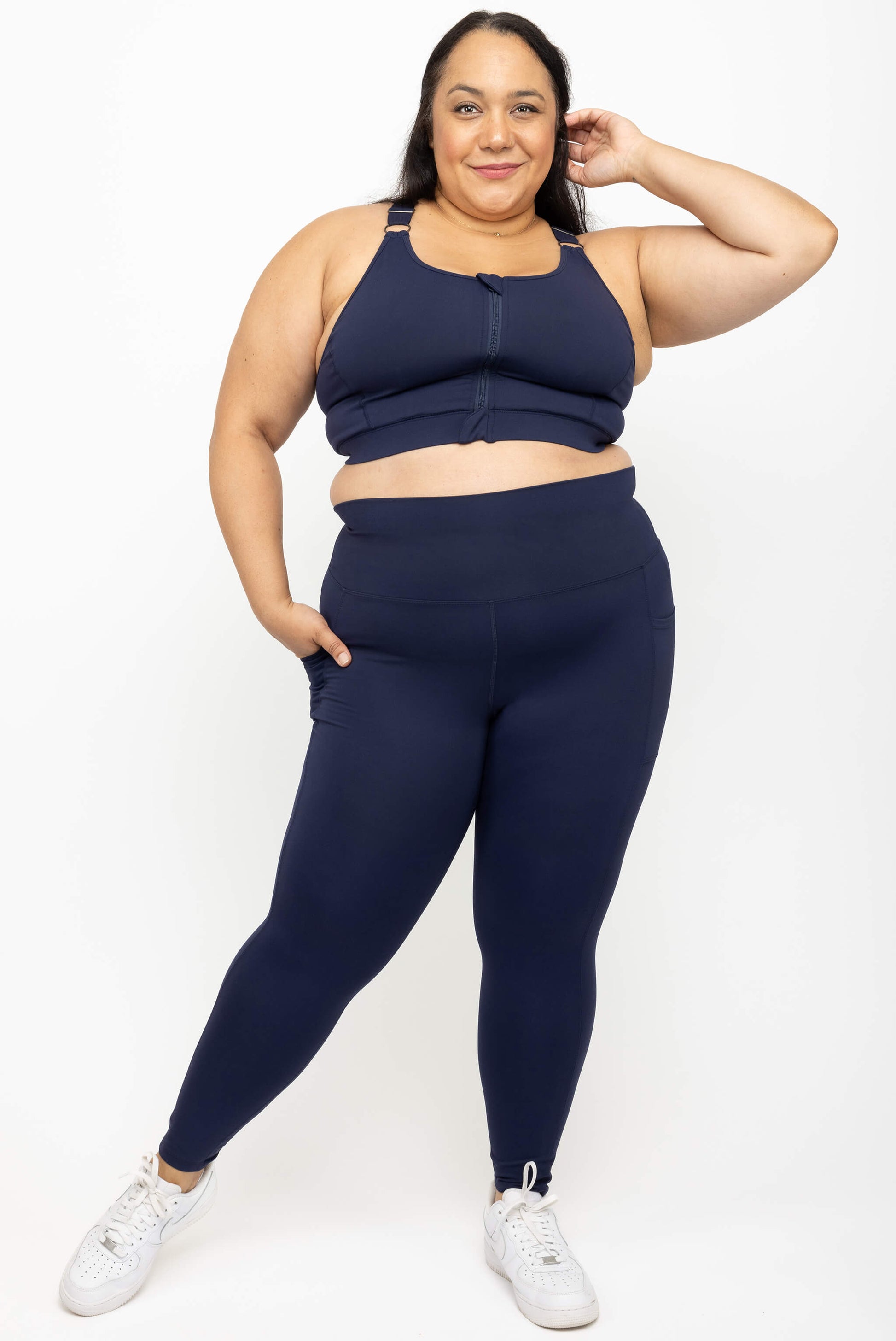 Model wearing Superfit Hero navy plus size 7/8 compression leggings with pockets size 2X