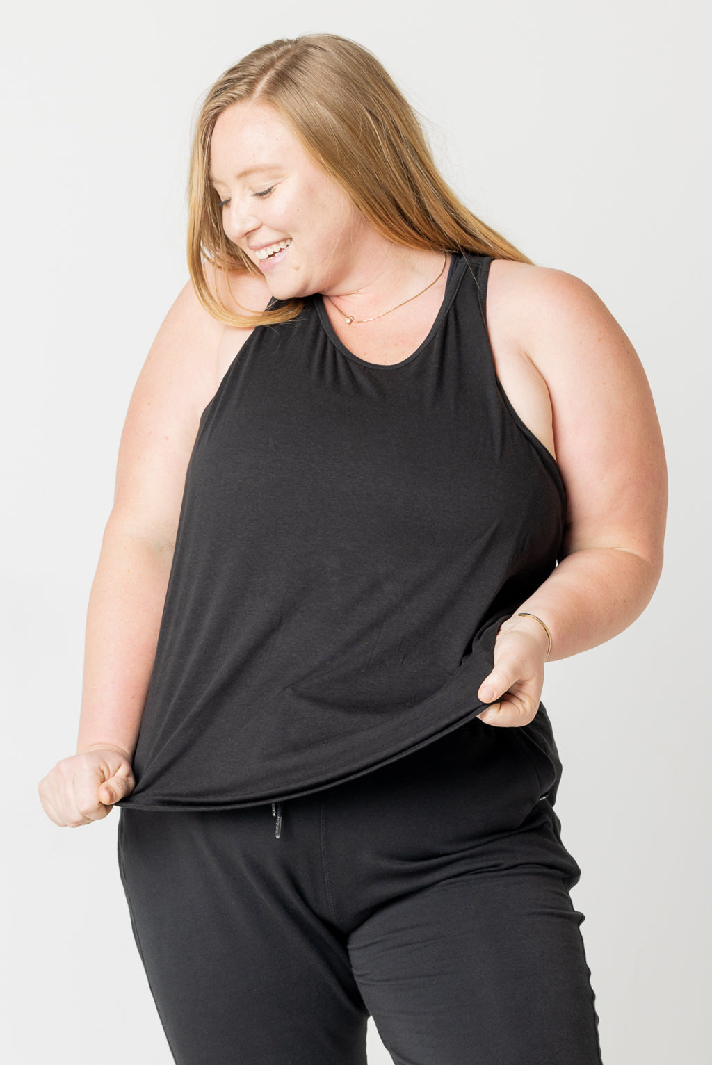Plus size model in black ribbed tank top size 2X